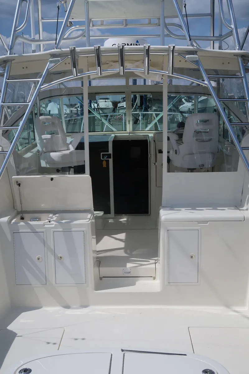 Slide: The Image of 2025 Henriques 30' Express boat interior with seating and storage compartments. - 11