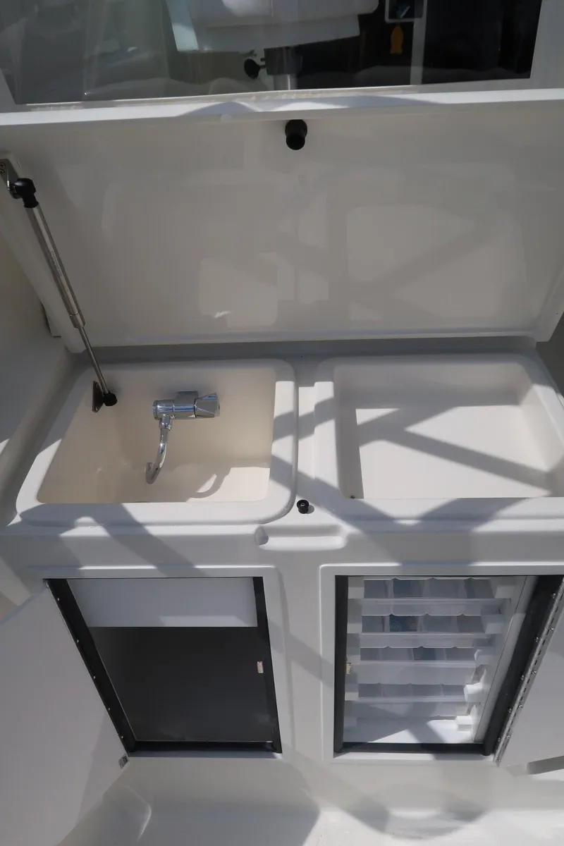 Slide: The Image of Henriques 30' Express 2025 boat interior sink and storage area - 12
