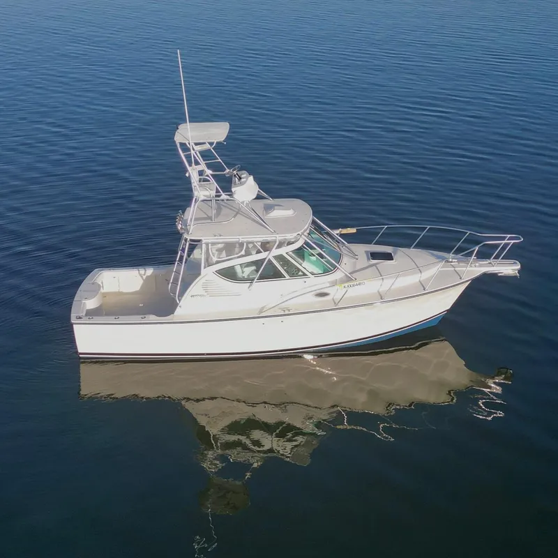 Slide: The Image of 2025 Henriques 30' Express boat on calm water, aerial view. - 2