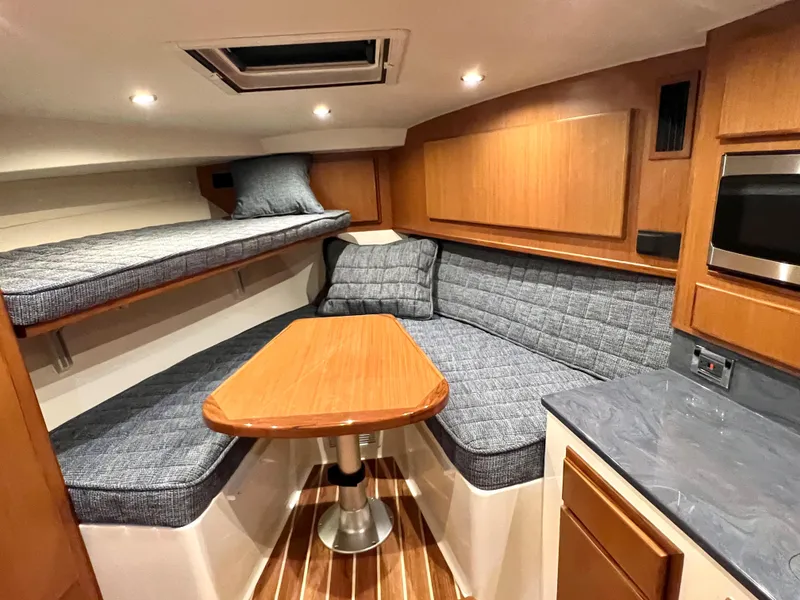 Slide: The Image of 2025 Henriques 30' Express cabin interior with cozy seating and modern amenities. - 20