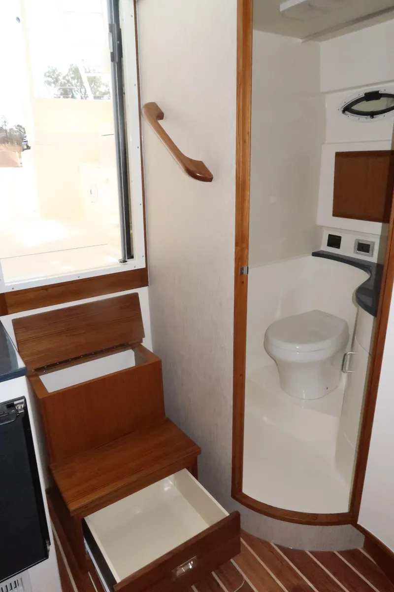 Slide: The Image of 2025 Henriques 30' Express boat interior with bathroom and storage drawers. - 22