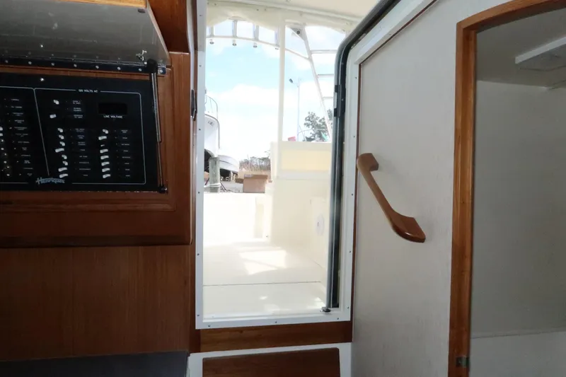 Slide: The Image of Interior view of 2025 Henriques 30' Express boat, showing cabin entrance and control panel. - 23