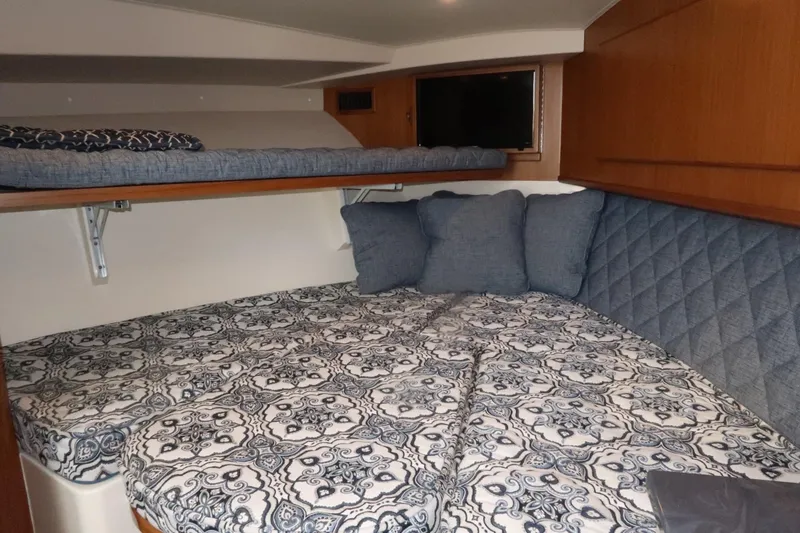 Slide: The Image of 2025 Henriques 30' Express cabin with double bed and upper bunk. - 27