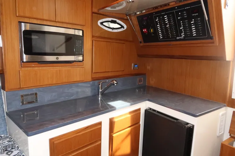 Slide: The Image of Modern galley kitchen in 2025 Henriques 30' Express boat with microwave and sink. - 28