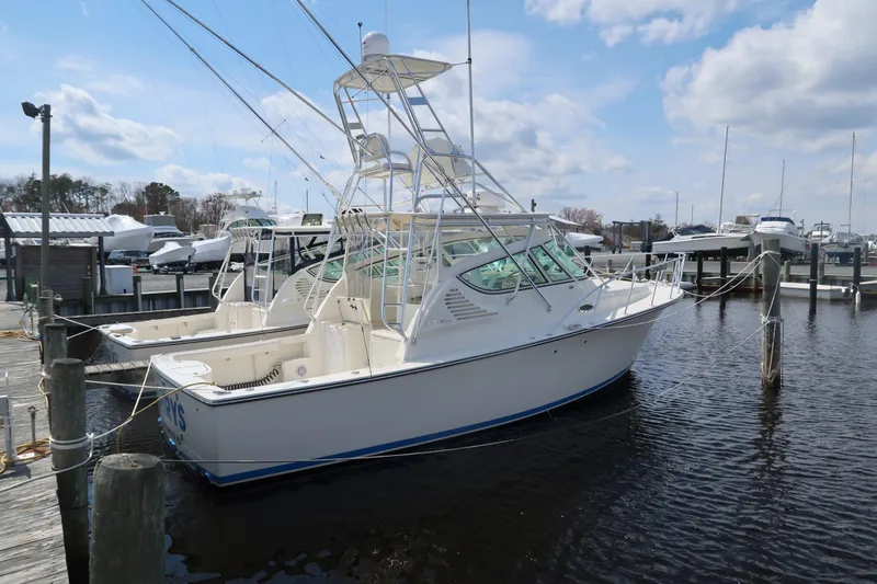 Slide: The Image of 2025 Henriques 30' Express boat docked at a marina on a sunny day. - 6