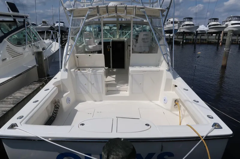 Slide: The Image of 2025 Henriques 30' Express boat docked at marina, spacious deck, and fishing setup. - 7