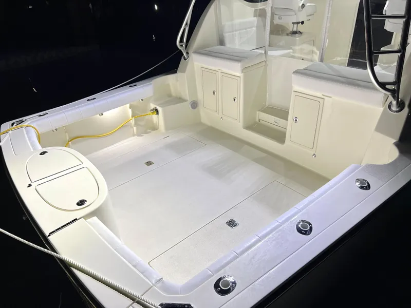 Slide: The Image of 2025 Henriques 30' Express boat deck with storage compartments and seating. - 8