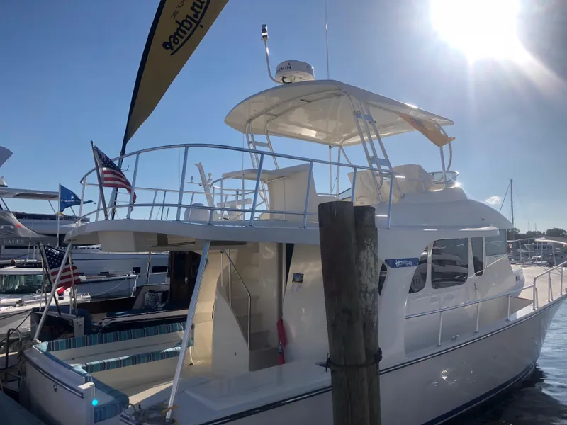 Slide: The Image of 2025 Henriques 42 Cruiser yacht docked at marina under sunny sky. - 14