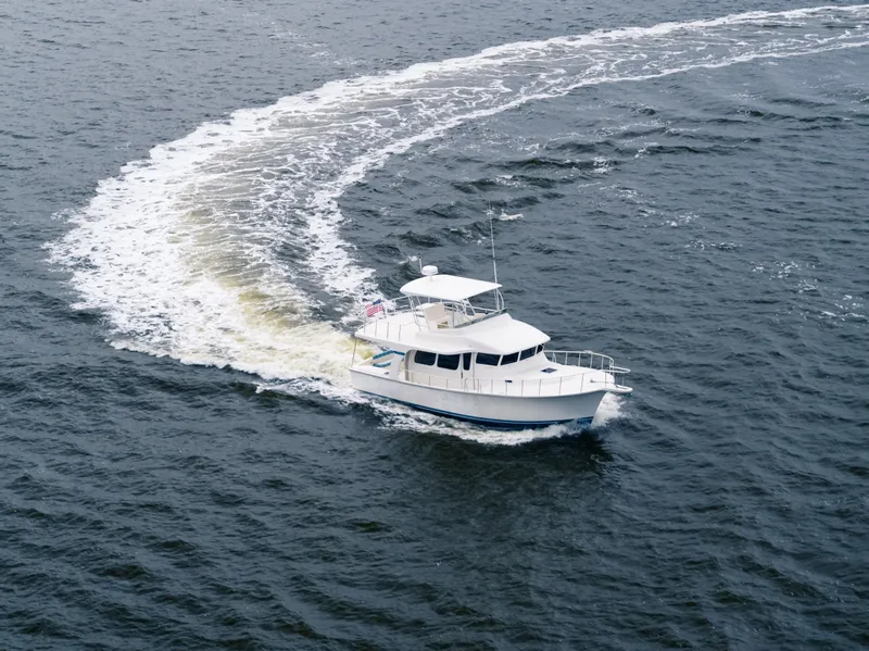 Slide: The Image of 2025 Henriques 42 Cruiser yacht navigating on open water. - 2