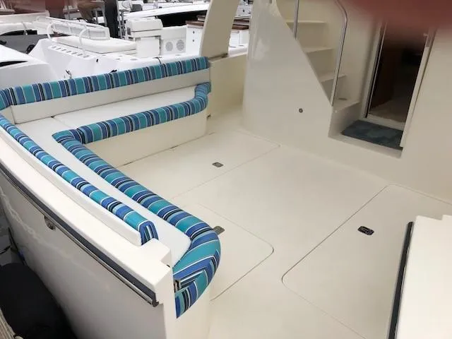 Slide: The Image of Henriques 42 Cruiser 2025 model with spacious deck and striped seating. - 5