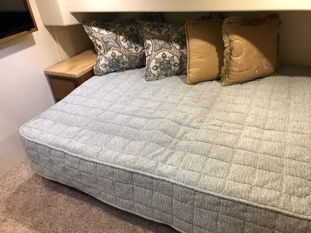 Slide: The Image of Henriques 42 Cruiser 2025 interior cabin bed with decorative pillows. - 8