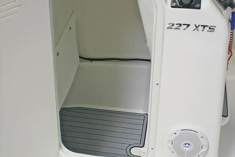 Slide: The Image of 2023 NauticStar 227 XTS interior compartment with non-slip flooring. - 17