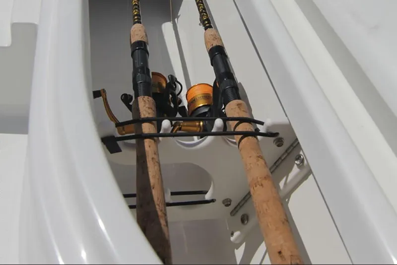 Slide: The Image of 2023 NauticStar 227 XTS fishing rod holders in storage compartment. - 18