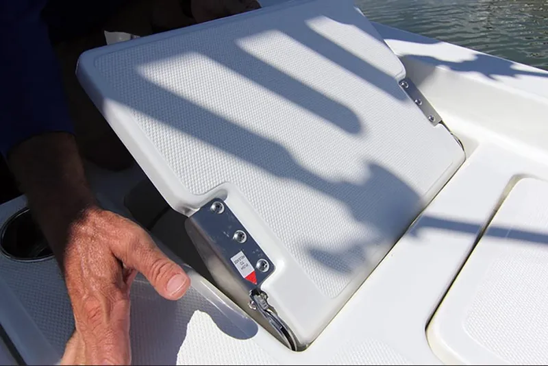 Slide: The Image of 2023 NauticStar 227 XTS boat seat compartment being opened. - 19