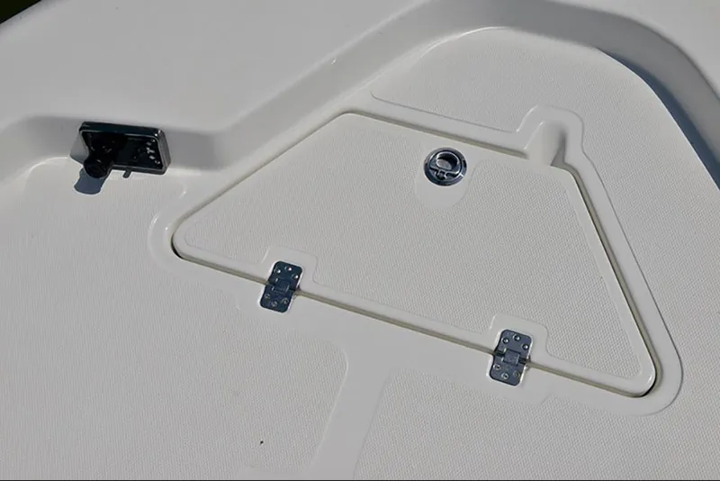 Slide: The Image of 2023 NauticStar 227 XTS boat storage compartment with latch and hinges. - 8
