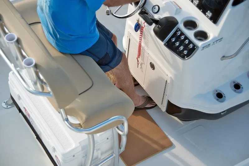 Slide: The Image of 2023 NauticStar 215 XTS boat interior with captain at the helm. - 15
