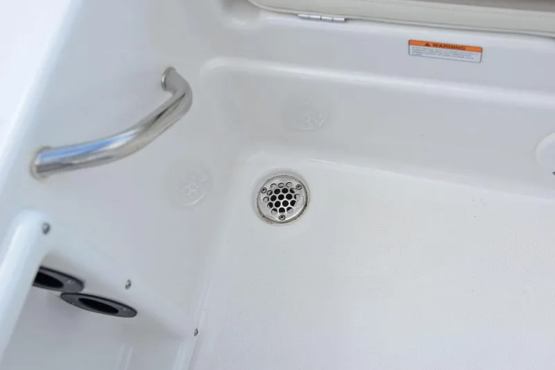 Slide: The Image of 2023 NauticStar 215 XTS boat interior with stainless steel drain and handrail. - 19