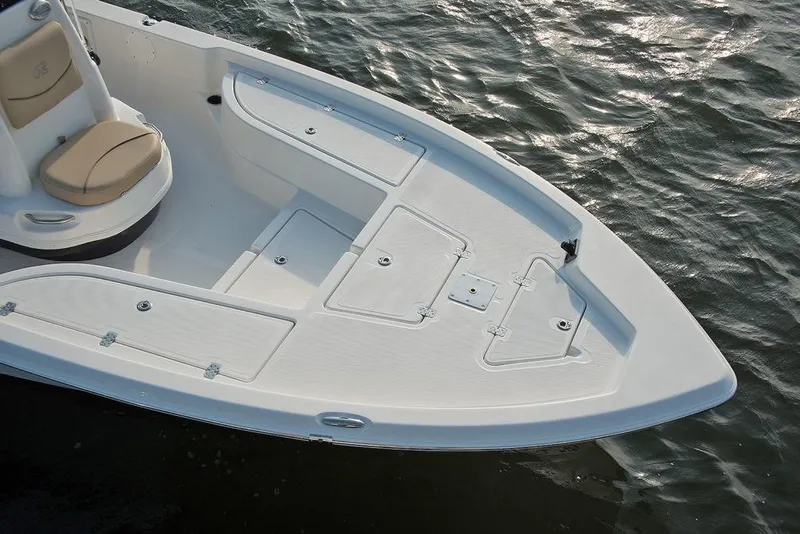 Slide: The Image of 2023 NauticStar 215 XTS boat bow with storage compartments on water. - 6