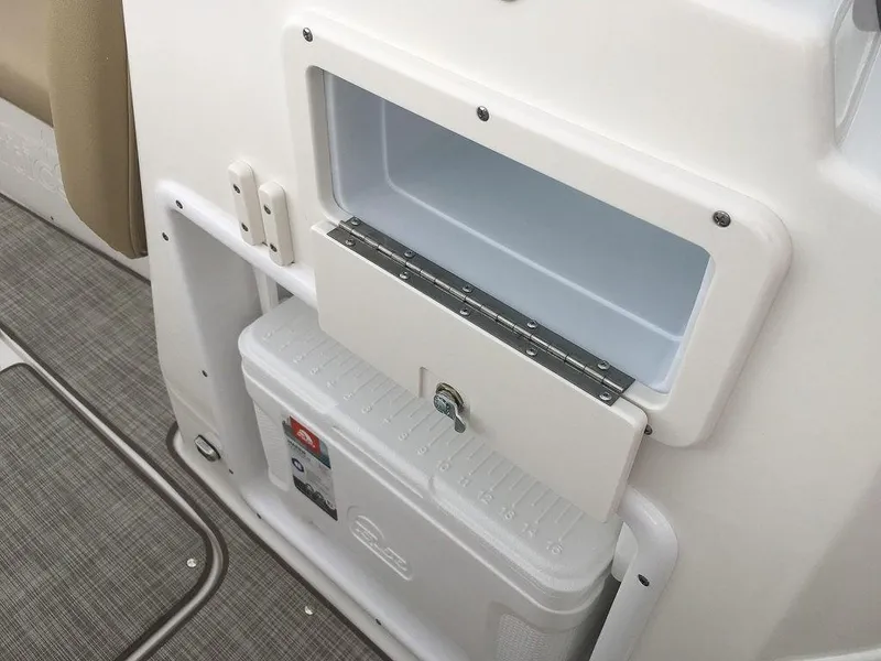 Slide: The Image of 2023 NauticStar 223DC Sport Deck storage compartment and cooler. - 16