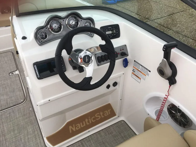 Slide: The Image of 2023 NauticStar 223DC Sport Deck boat dashboard with steering wheel and control panel. - 18