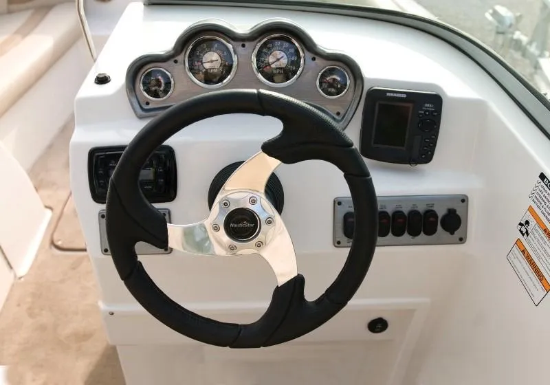 Slide: The Image of 2023 NauticStar 223DC Sport Deck steering console with gauges and controls. - 19