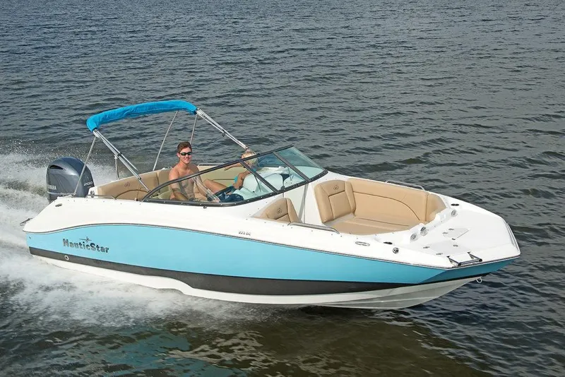 Slide: The Image of 2023 NauticStar 223DC Sport Deck boat cruising on water. - 3