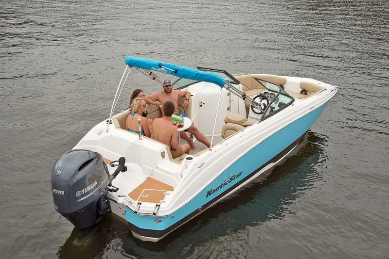 Slide: The Image of 2023 NauticStar 223DC Sport Deck boat with passengers on a lake. - 4