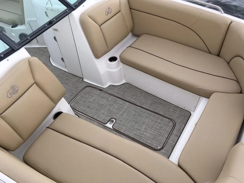 Slide: The Image of 2023 NauticStar 223DC Sport Deck boat interior with tan seating and gray flooring. - 9