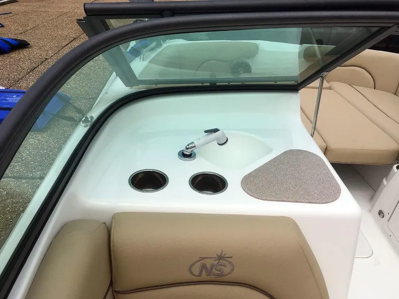 Slide: The Image of 2023 NauticStar 203DC Sport Deck interior with sink and cup holders. - 10