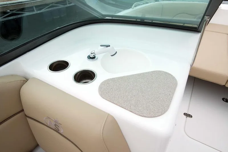 Slide: The Image of 2023 NauticStar 203DC Sport Deck interior with sink and cup holders. - 11