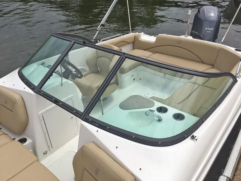 Slide: The Image of 2023 NauticStar 203DC Sport Deck boat interior with tan seating and windshield. - 14