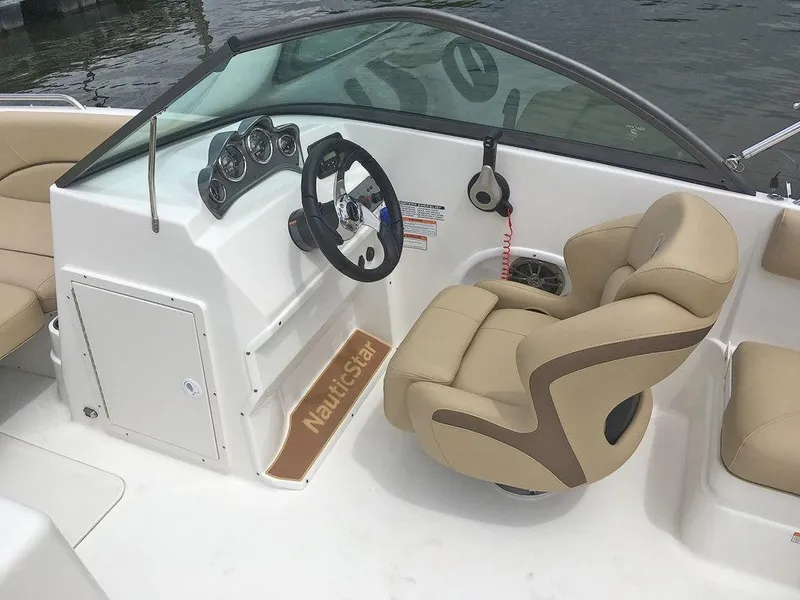 Slide: The Image of 2023 NauticStar 203DC Sport Deck boat interior with steering wheel and captain's chair. - 15