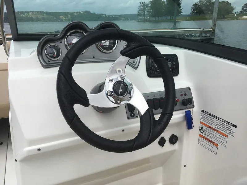 Slide: The Image of Steering wheel and dashboard of 2023 NauticStar 203DC Sport Deck boat. - 16