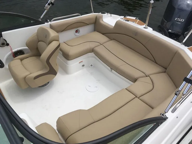 Slide: The Image of 2023 NauticStar 203DC Sport Deck boat with spacious tan seating and modern design. - 18