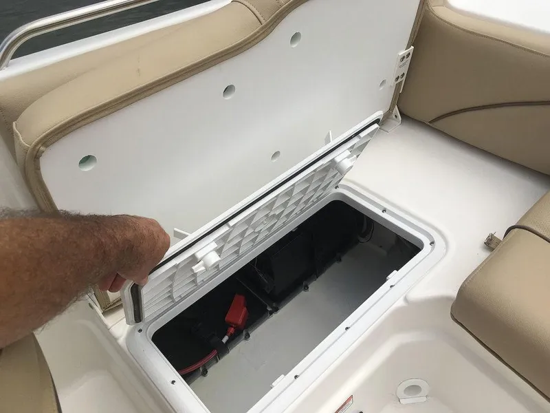 Slide: The Image of 2023 NauticStar 203DC Sport Deck storage compartment with open hatch. - 20