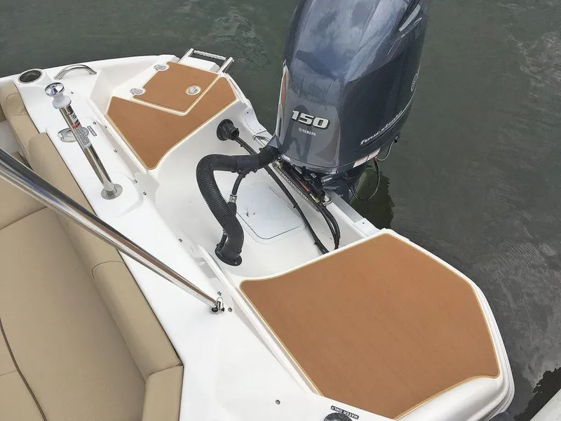 Slide: The Image of 2023 NauticStar 203DC Sport Deck boat with Yamaha 150 outboard motor. - 21
