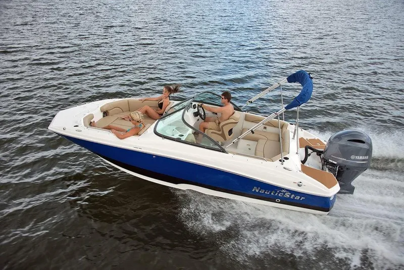 Slide: The Image of 2023 NauticStar 203DC Sport Deck boat cruising on water. - 4