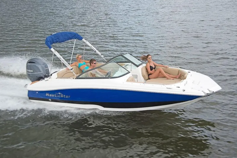 Slide: The Image of 2023 NauticStar 203DC Sport Deck boat cruising on water with passengers. - 5