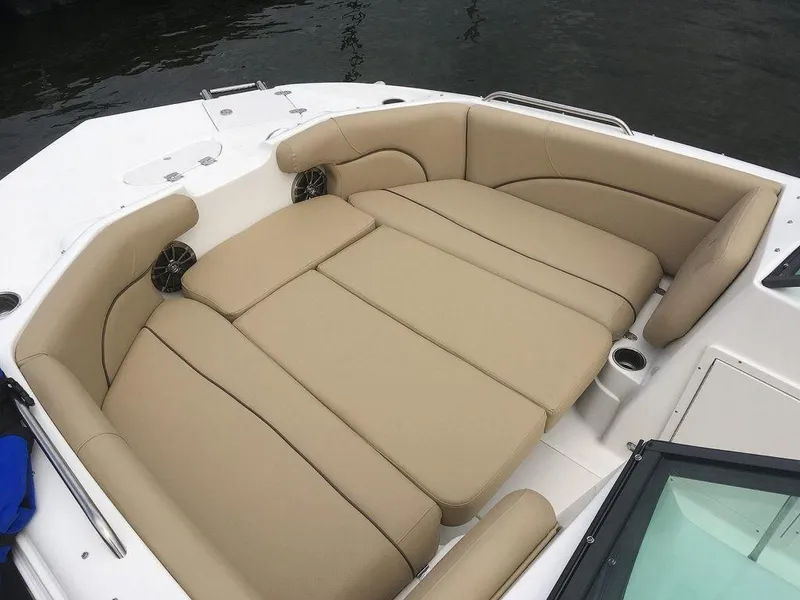 Slide: The Image of 2023 NauticStar 203DC Sport Deck boat with spacious tan seating area. - 7