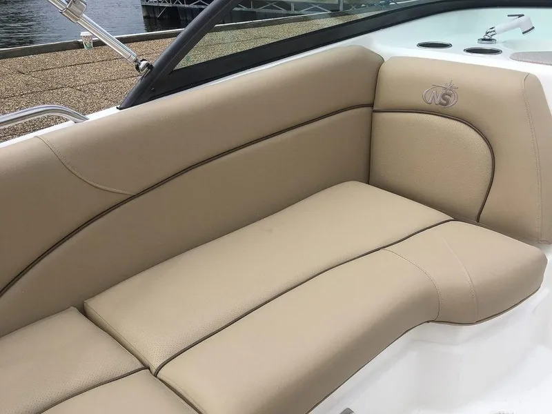 Slide: The Image of 2023 NauticStar 203DC Sport Deck boat with beige leather seating. - 9