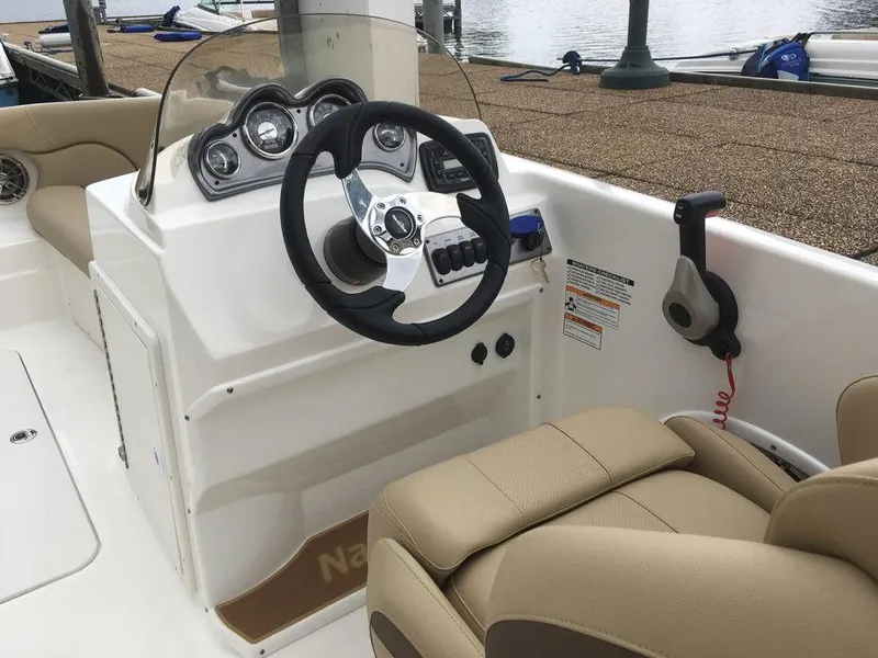 Slide: The Image of 2023 NauticStar 203SC Sport Deck boat interior with steering wheel and dashboard. - 13