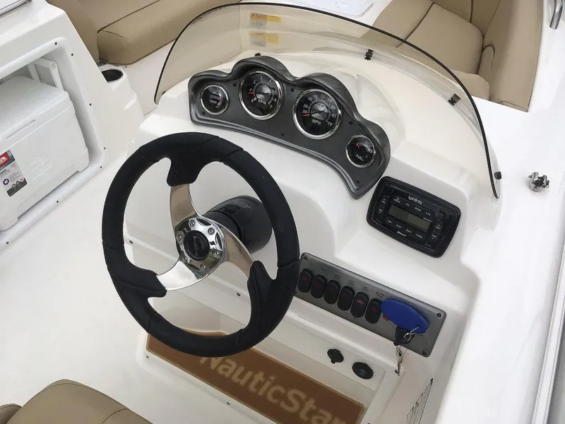 Slide: The Image of 2023 NauticStar 203SC Sport Deck boat dashboard with steering wheel and instrument panel. - 14