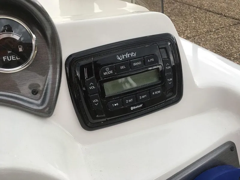 Slide: The Image of 2023 NauticStar 203SC Sport Deck dashboard with Infinity Bluetooth stereo system. - 16