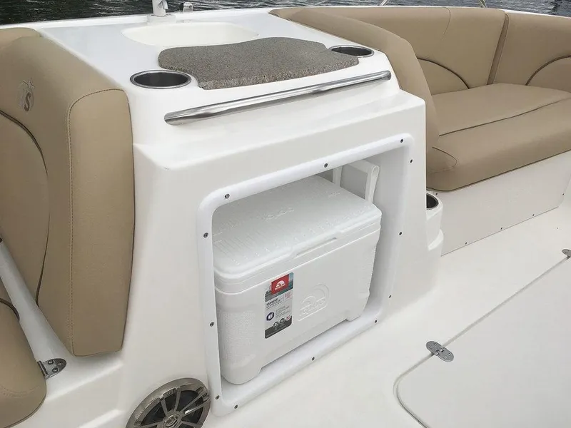 Slide: The Image of 2023 NauticStar 203SC Sport Deck interior with cooler storage and seating. - 20