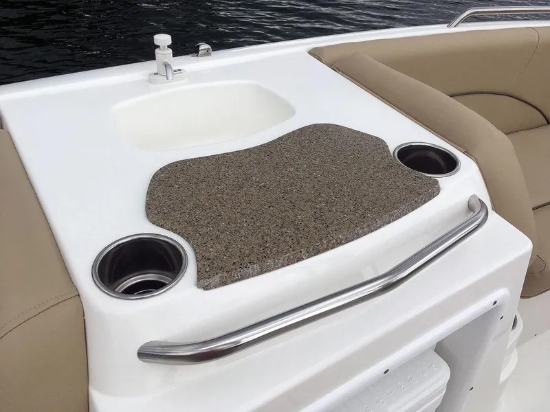 Slide: The Image of 2023 NauticStar 203SC Sport Deck boat interior with sink and cup holders. - 21