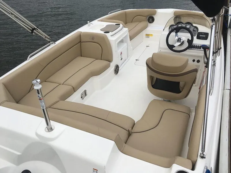 Slide: The Image of 2023 NauticStar 203SC Sport Deck boat interior with beige seating. - 24