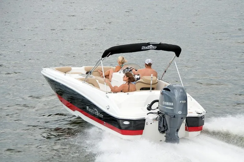 Slide: The Image of 2023 NauticStar 203SC Sport Deck boat cruising on water. - 3