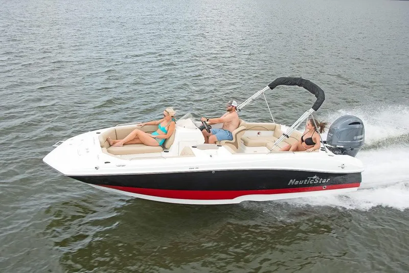 Slide: The Image of 2023 NauticStar 203SC Sport Deck boat cruising on water with passengers. - 4