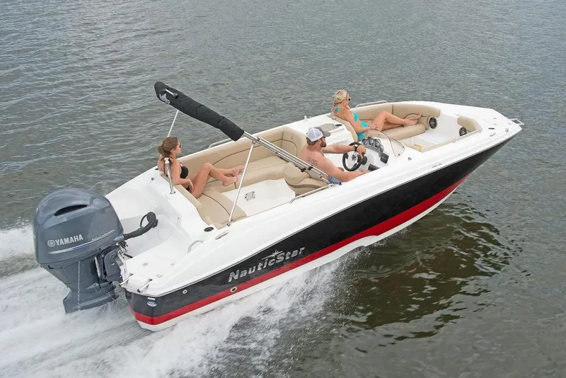 Slide: The Image of 2023 NauticStar 203SC Sport Deck boat cruising on water with passengers. - 5