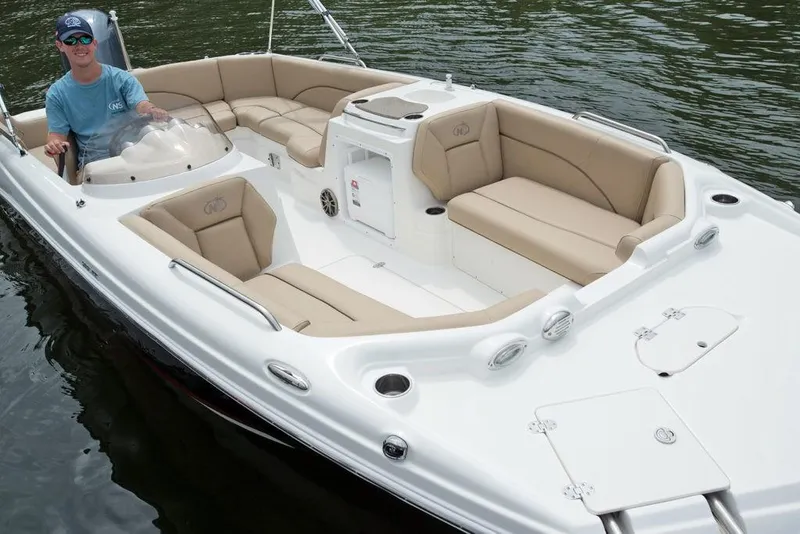 Slide: The Image of 2023 NauticStar 203SC Sport Deck boat on water, featuring spacious seating and modern design. - 6